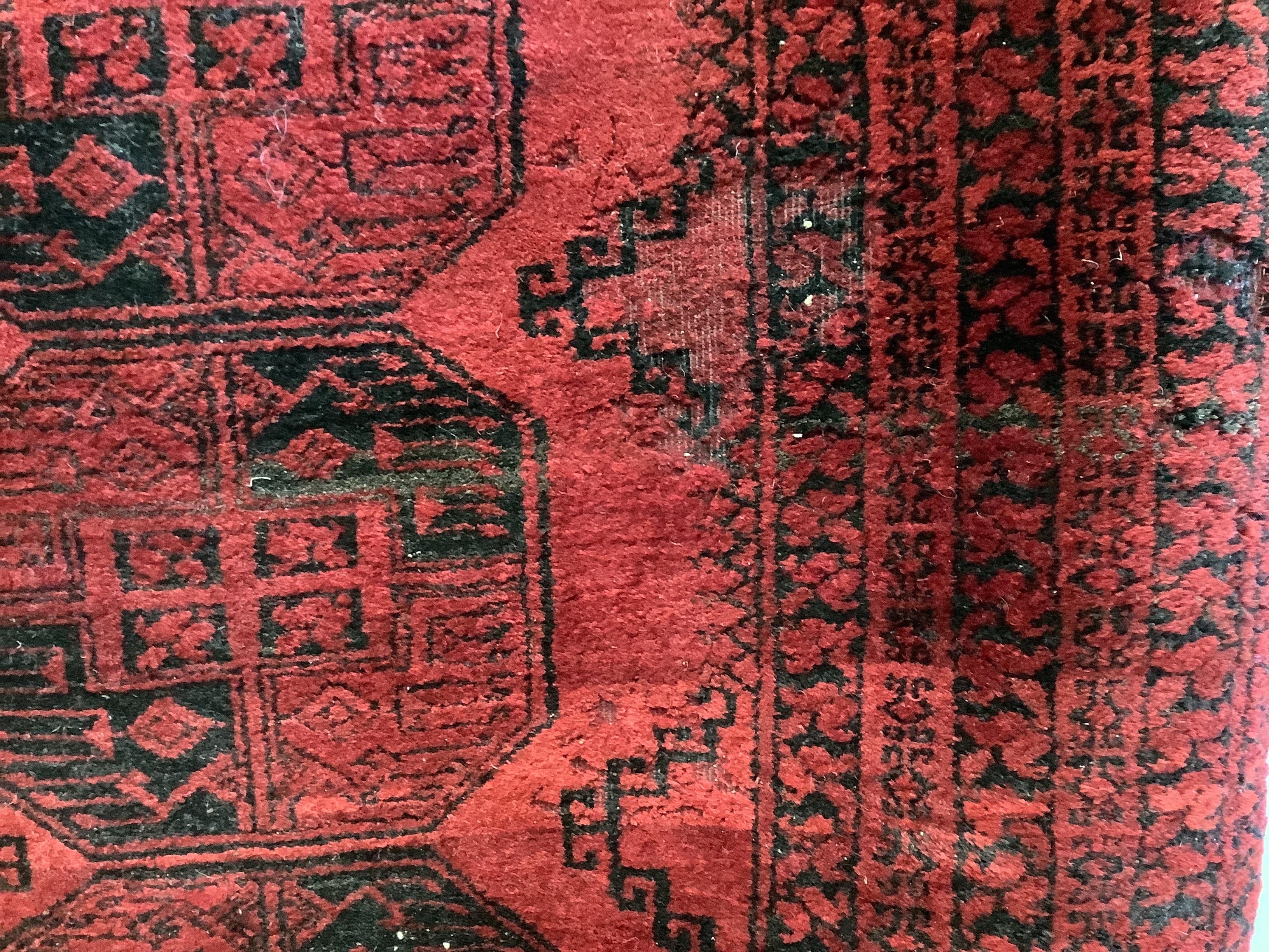 An Afghan red ground rug, 220 x 170cm together with a Bokhara rug
